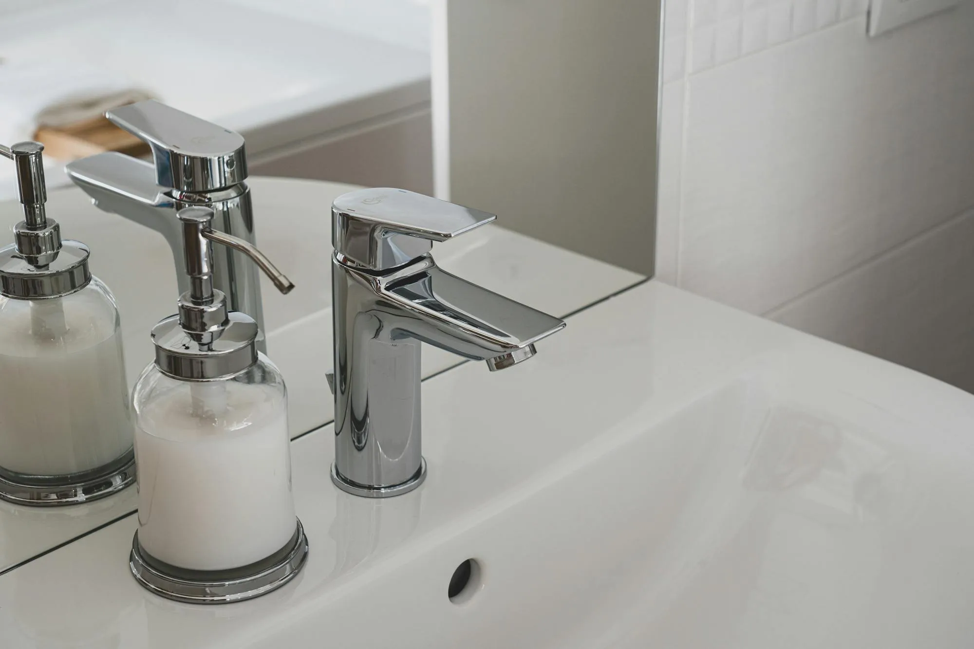 Chrome single-lever basin tap on a clean white bathroom sink, recently fitted